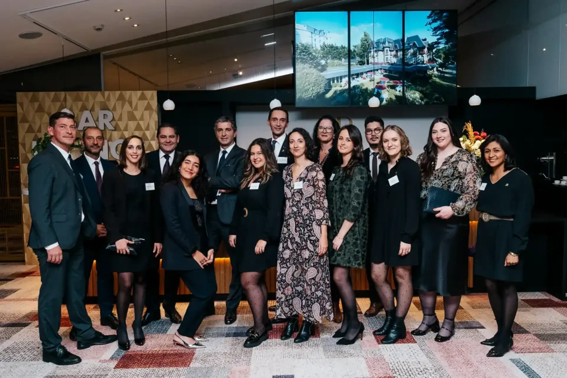 Groupe de professionnels réunis pour un portrait d'équipe lors d'un événement.
